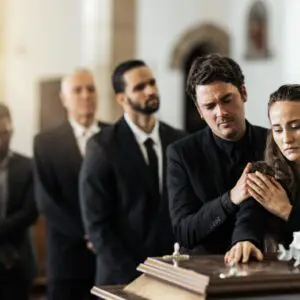 People mourning at a funeral service in a church.
