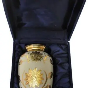 Ornate cream-colored vase with gold floral design in a black satin-lined box.